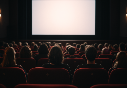 Cinema audience sitting in the dark waiting for the film to start